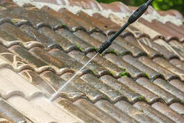 Pressure washing dirty old roof